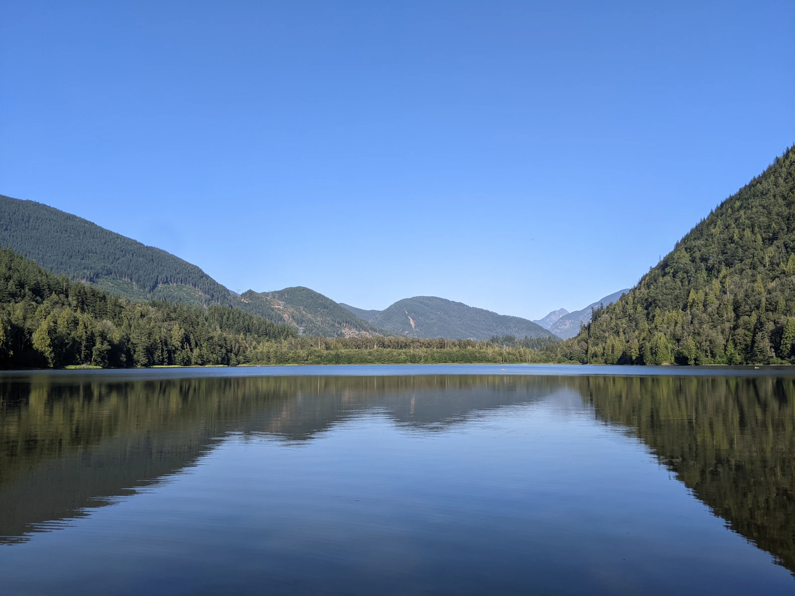 Forest and mountain reflections at Deer Lake, British Columbia